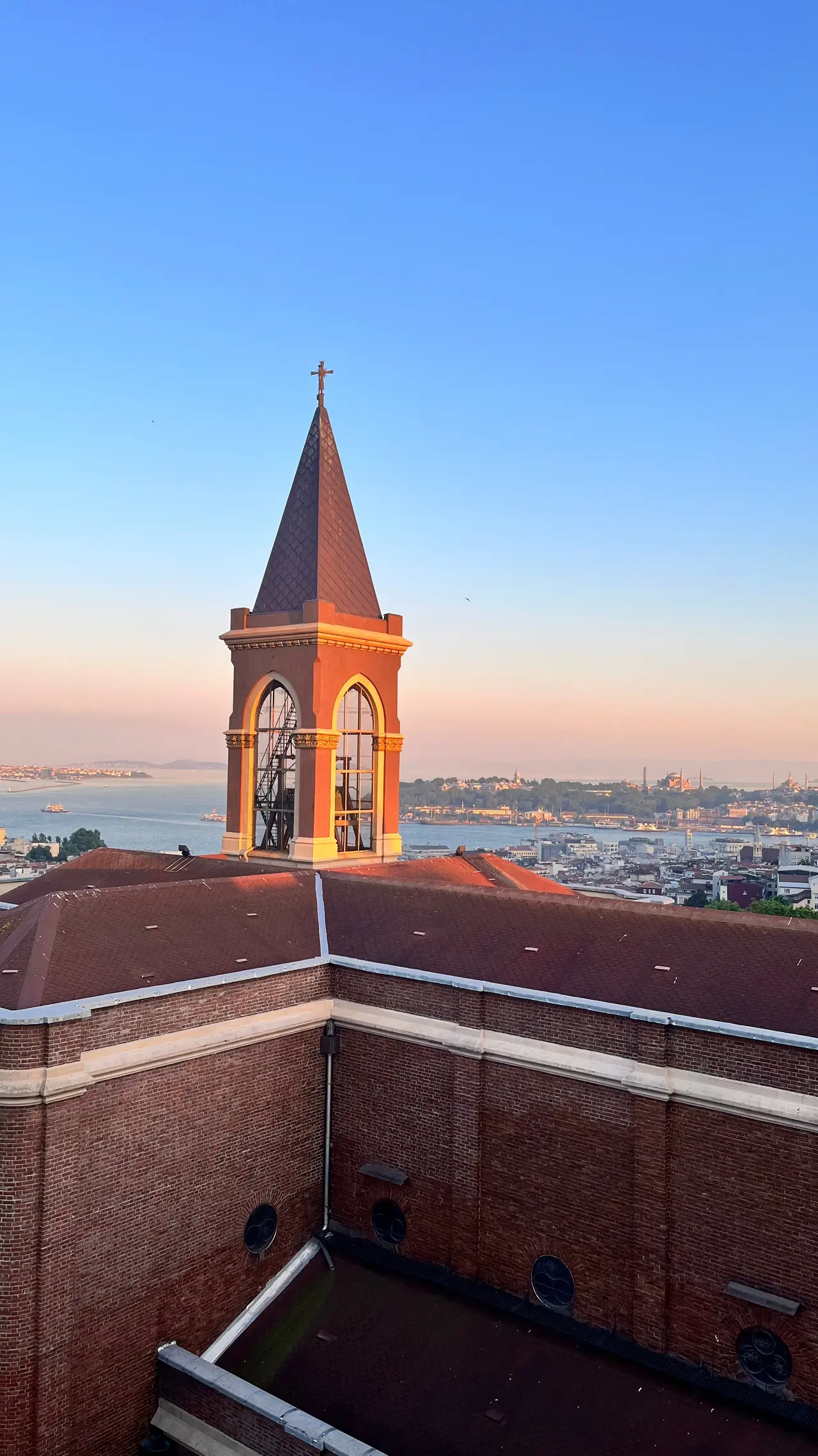 The bell tower of Saint Antoine Church at blue hour above the rooftops of Beyoğlu